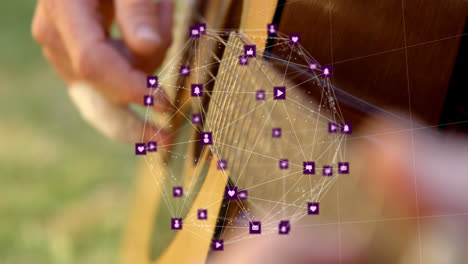 Animation-Eines-Globus-Mit-Netzwerkverbindungen-Und-Symbolen-über-Einem-Kaukasischen-Mann,-Der-Gitarre-Spielt