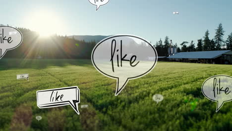 Animation-of-like-text-on-multiple-speech-bubbles-floating-against-aerial-view-of-grassland