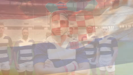 Animation-Der-Kroatischen-Flagge-über-Einem-Team-Verschiedener-Männlicher-Rugbyspieler,-Die-Zusammen-Auf-Dem-Rugbyfeld-Stehen