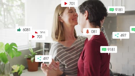 Animation-of-social-media-icons-and-numbers-over-lesbian-caucasian-couple-at-home
