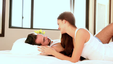 Attractive-couple-lying-in-bed-in-the-morning