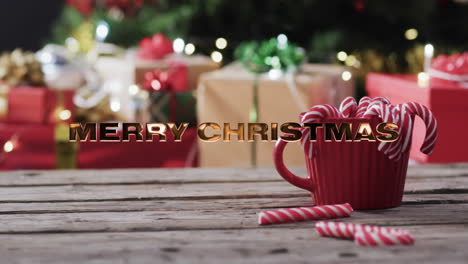 Frohe-Weihnachten-Text-In-Gold-über-Zuckerstangen-Und-Weihnachtsgeschenke