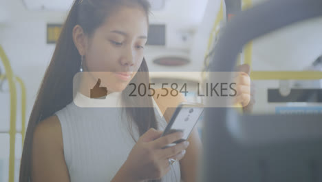 Animation-of-social-media-reactions-over-happy-asian-girl-using-smartphone