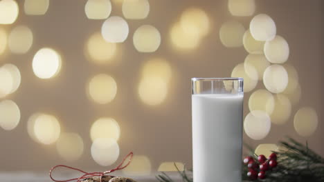 Video-of-christma-cookies,-glass-of-miljk-and-copy-space-on-wooden-background