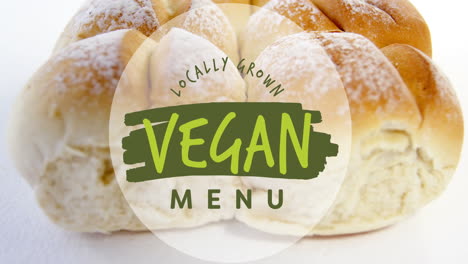 Animation-of-locally-grown-vegan-menu-text-banner-against-close-up-of-fresh-bread