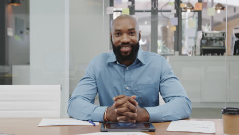 Portrait-of-smiling-african-american-businessman-with-beard-making-video-call-in-office,-slow-motion