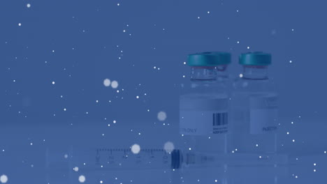 Animation-of-spots-of-light-over-vaccine-bottles-and-syringe
