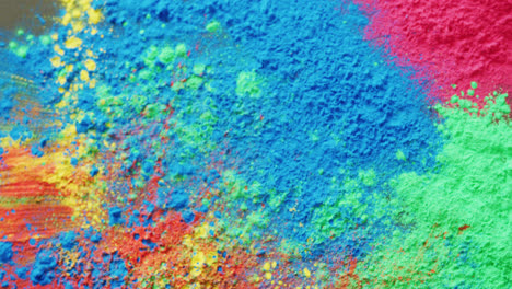 Video-of-close-up-of-multi-coloured-powders-with-copy-space-on-black-background
