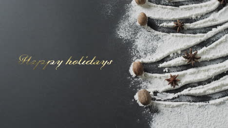Happy-holidays-text-in-gold-over-christmas-tree-drawn-in-flour-on-grey-background