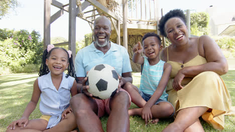Portrait-of-happy-african-american-grandparents-with-grandchildren-in-garden,-in-slow-motion
