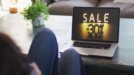 Woman-at-table-using-laptop,-online-shopping-during-sale,-slow-motion