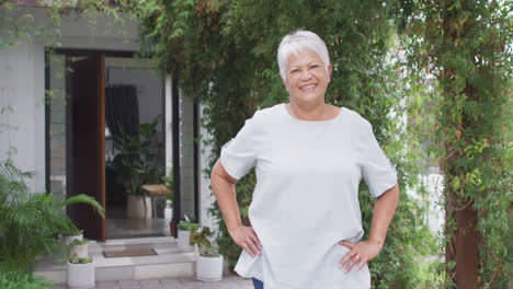 Portrait-of-happy-senior-caucasian-woman-looking-at-camera-in-garden