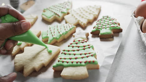 Video-of-christma-cookies-being-decorated-with-green-sugar-icing-with-copy-space-on-white-background
