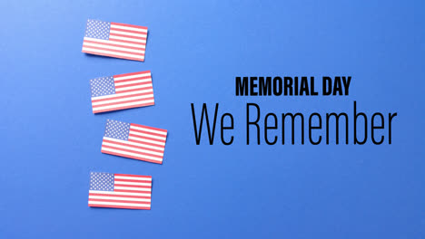 Animation-Des-Memorial-Day-Textes-über-Flaggen-Der-Vereinigten-Staaten-Von-Amerika-Auf-Blauem-Hintergrund