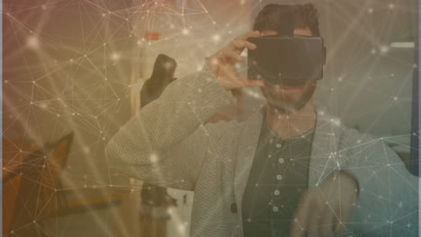 Animation-of-connecting-dots-over-caucasian-businessman-using-virtual-reality-simulator-in-office