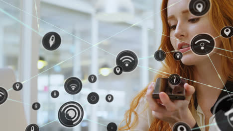 Animation-of-network-of-connections-with-icons-over-caucasian-businesswoman-talking-on-smartphone