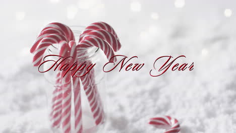 Frohes-Neues-Jahr-Text-In-Rot-über-Weihnachten-Zuckerstangen-Auf-Schnee-Hintergrund