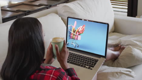 Biracial-woman-using-laptop-at-home-for-online-shopping,-slow-motion