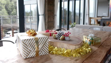 Close-up-of-presents-and-decorations-on-table-in-living-room,-slow-motion