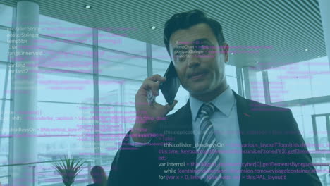Animation-of-multicolored-computer-language-over-caucasian-businessman-talking-on-cellphone