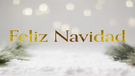 Feliz-navidad-text-in-gold-over-christmas-tree-sprigs,-snow-and-bokeh-lights-on-grey-background