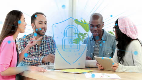 Animation-of-security-padlock-icon-against-diverse-colleagues-discussing-over-a-laptop-at-office