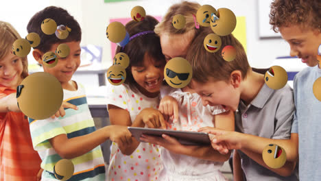 Animation-of-emoticons-floating-over-diverse-children-laughing-and-using-digital-tablet-in-classroom