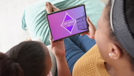 African-american-mother-and-daughter-using-tablet,-online-shopping-on-cyber-monday,-slow-motion