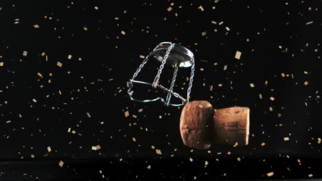 Animation-of-silver-confetti-over-champagne-bottle-cork-falling-against-black-background