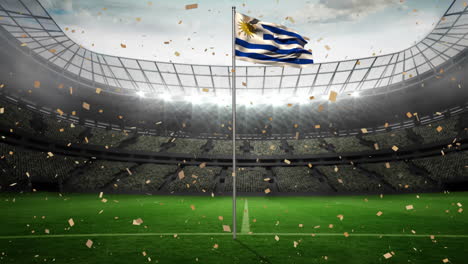 Uruguayan-flag-waves-proudly-in-a-stadium,-celebrating-a-momentous-event