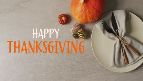 Animation-of-happy-thanksgiving-text-and-cutlery-and-autumn-pumpkin-over-grey-background