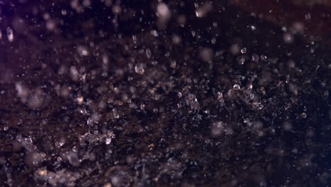 Animation-of-water-drops-falling-on-black-background