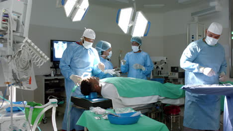Diverse-team-of-surgeons-operate-in-a-hospital,-with-copy-space