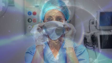 Animation-of-globe-over-caucasian-female-surgeon-with-face-mask