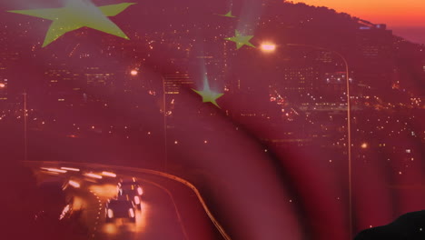 Animation-of-waving-chinese-flag-against-aerial-view-of-night-city-traffic