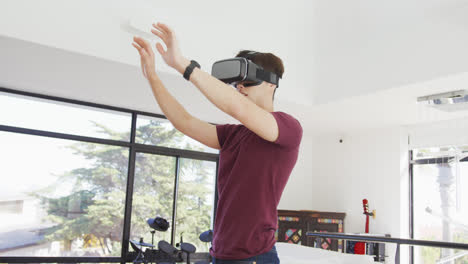 Asian-boy-wearing-vr-headset-gesturing-in-living-room-at-home