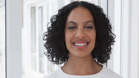 Portrait-of-happy-biracial-woman-at-home,-slow-motion
