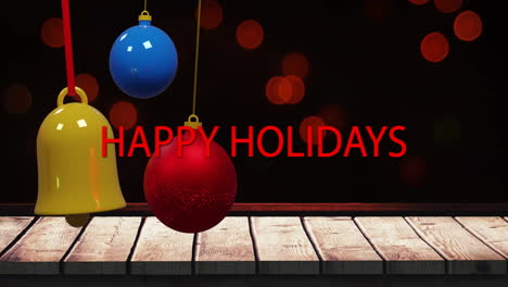 Animation-of-red-happy-holidays-text-with-colorful-baubles-and-bell-over-lens-flares-and-table