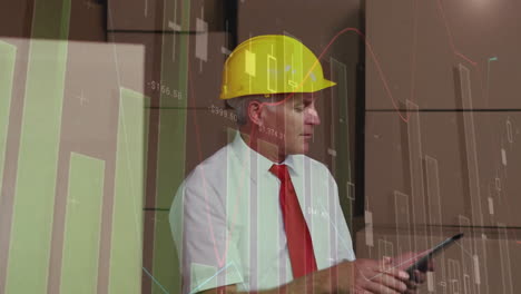Animation-of-multiple-graphs-over-caucasian-manager-wearing-helmet-using-digital-tablet-in-warehouse