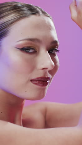 Vertical-video-of-caucasian-woman-with-brown-hair-and-make-up,-copy-space,-slow-motion