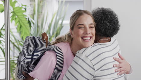 Smiling-caucasian-nurse-hugging-with-senior-african-american-woman-patient,-slow-motion