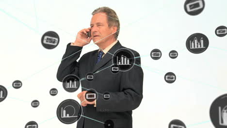 Animation-of-connected-icons,-caucasian-man-talking-on-cellphone-while-standing-against-background