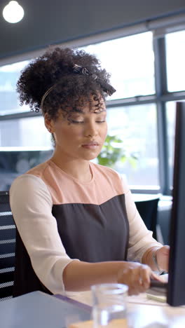 Vertical-video-of-african-american-businesswoman-using-smartphone-with-copy-space,-slow-motion