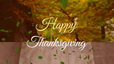 Animation-of-green-leaves-and-happy-thanksgiving-text-over-blocks-and-trees-against-sky