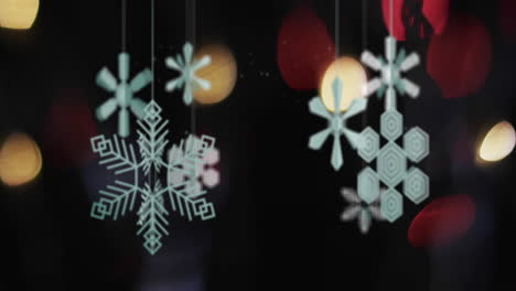 Animation-of-christmas-baubles-and-snow-falling-on-black-background