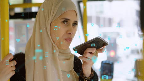 Animation-of-connected-icons,-biracial-woman-wearing-hijab-using-voice-assistant-in-bus