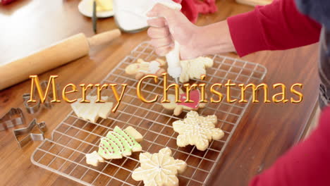 Animation-of-merry-christmas-text-over-caucasian-man-baking-cookies