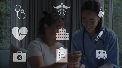 Animation-of-digital-icons-over-asian-female-doctor-with-patient-in-hospital