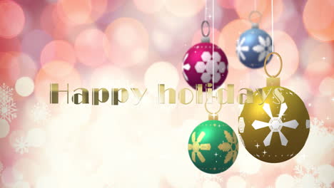 Animation-of-happy-holidays-text-over-and-christmas-baubles-on-pink-background