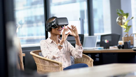 African-american-businesswoman-using-vr-headset-in-office,-slow-motion,-copy-space